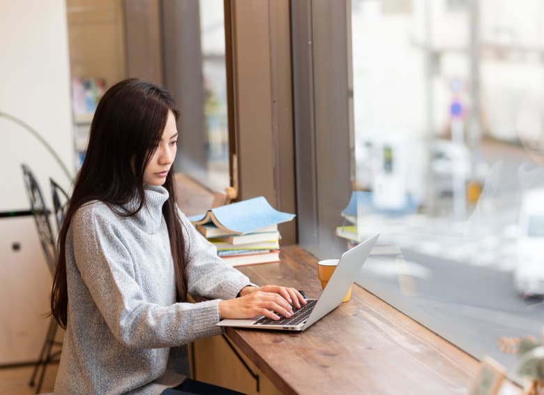 Translator reviewing a document at a laptop